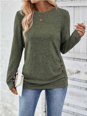 a woman wearing a green sweater and jeans