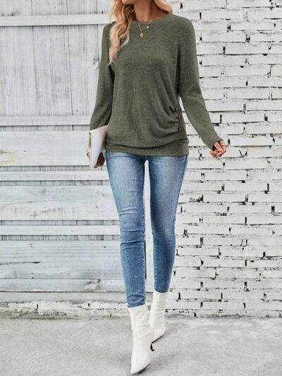 a woman standing in front of a white brick wall