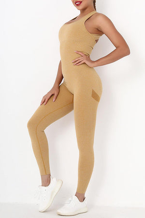a woman in a tan bodysuit posing for a picture