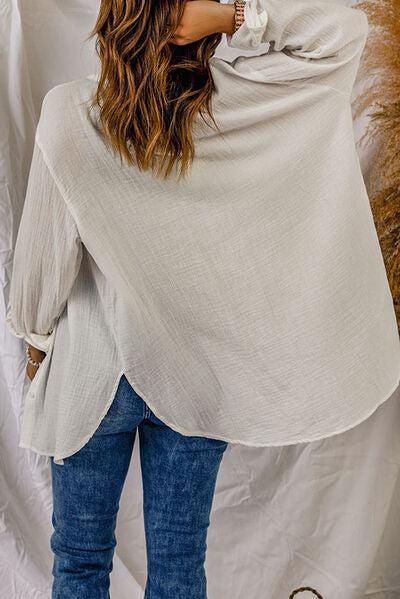 a woman standing in front of a white backdrop