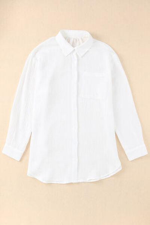 a white shirt hanging on a wall