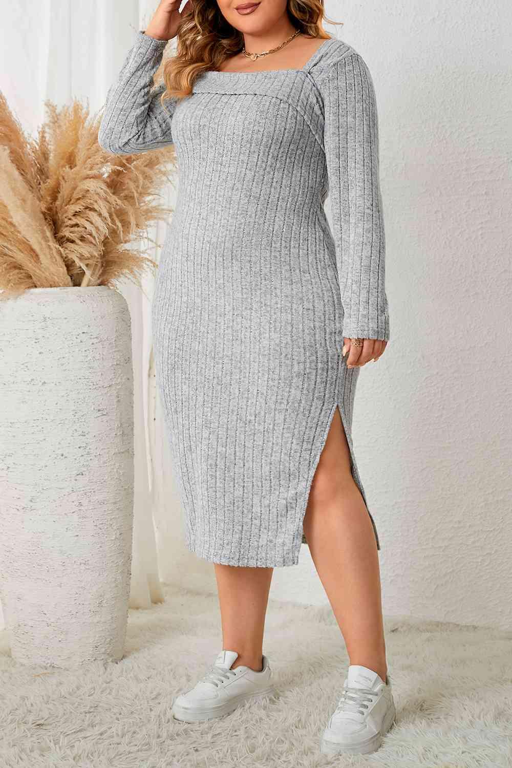 a woman wearing a grey sweater dress and sneakers
