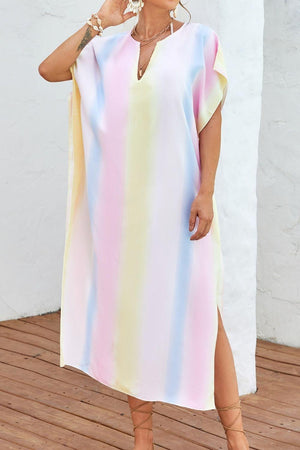 a woman standing on a deck wearing a colorful dress