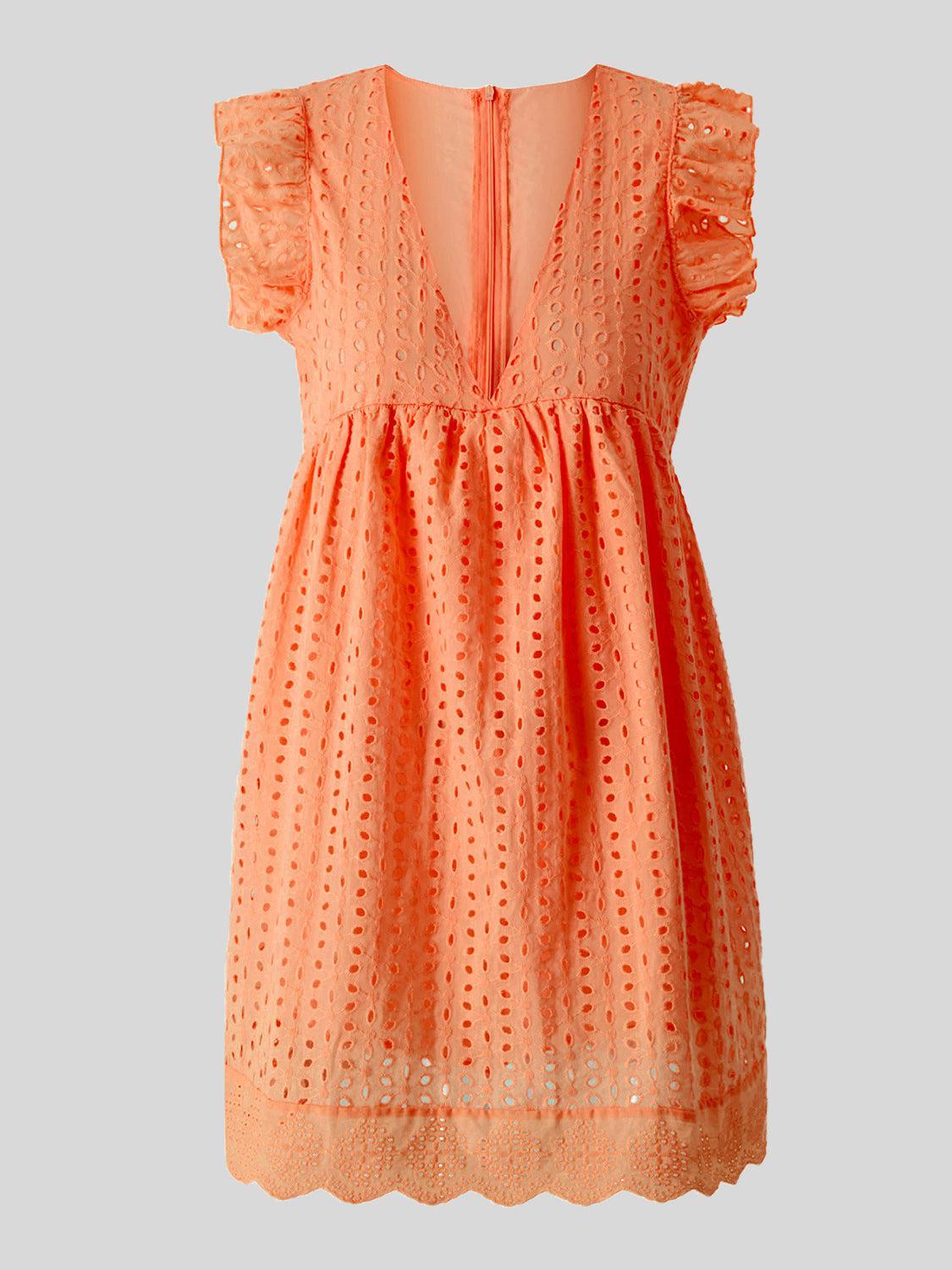 an orange dress with ruffles on the shoulders
