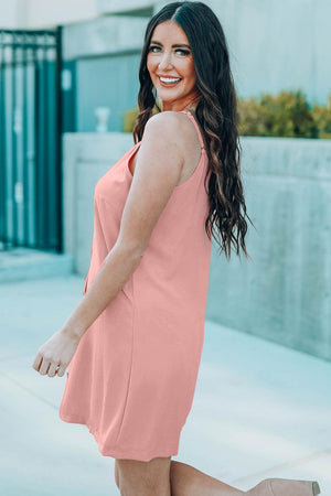 a woman in a pink dress is posing for a picture