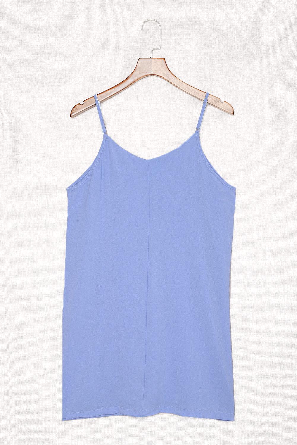 a blue top hanging on a wooden hanger