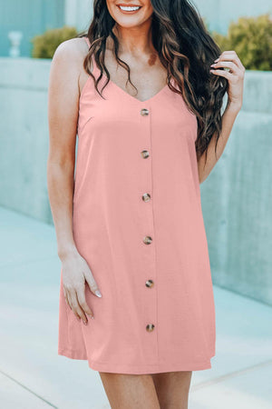 a woman in a pink dress posing for a picture