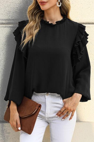 a woman wearing white jeans and a black top