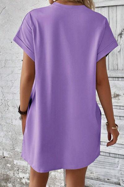 a woman wearing a purple shirt dress