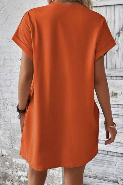 a woman wearing an orange shirt dress