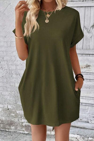 a woman wearing a green shirt dress