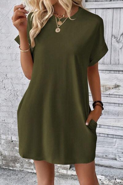 a woman wearing a green shirt dress