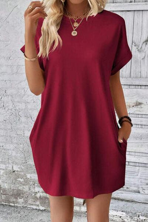 a woman wearing a red shirt dress