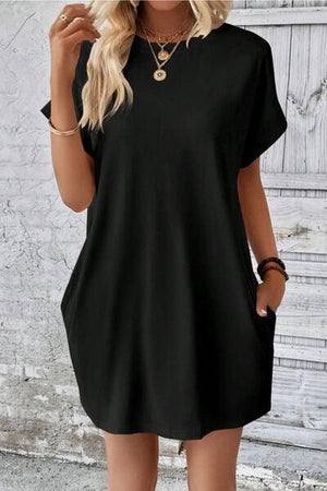 a woman wearing a black shirt dress