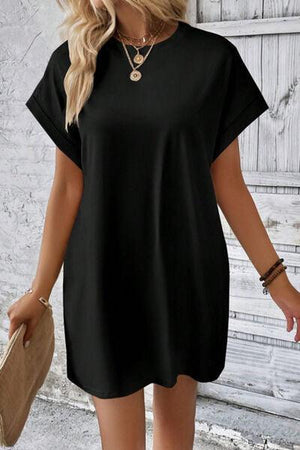 a woman wearing a black shirt dress