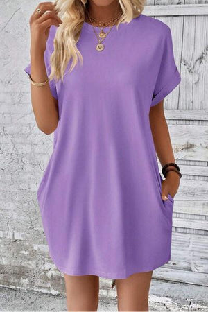 a woman wearing a purple shirt dress