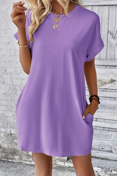 a woman wearing a purple shirt dress