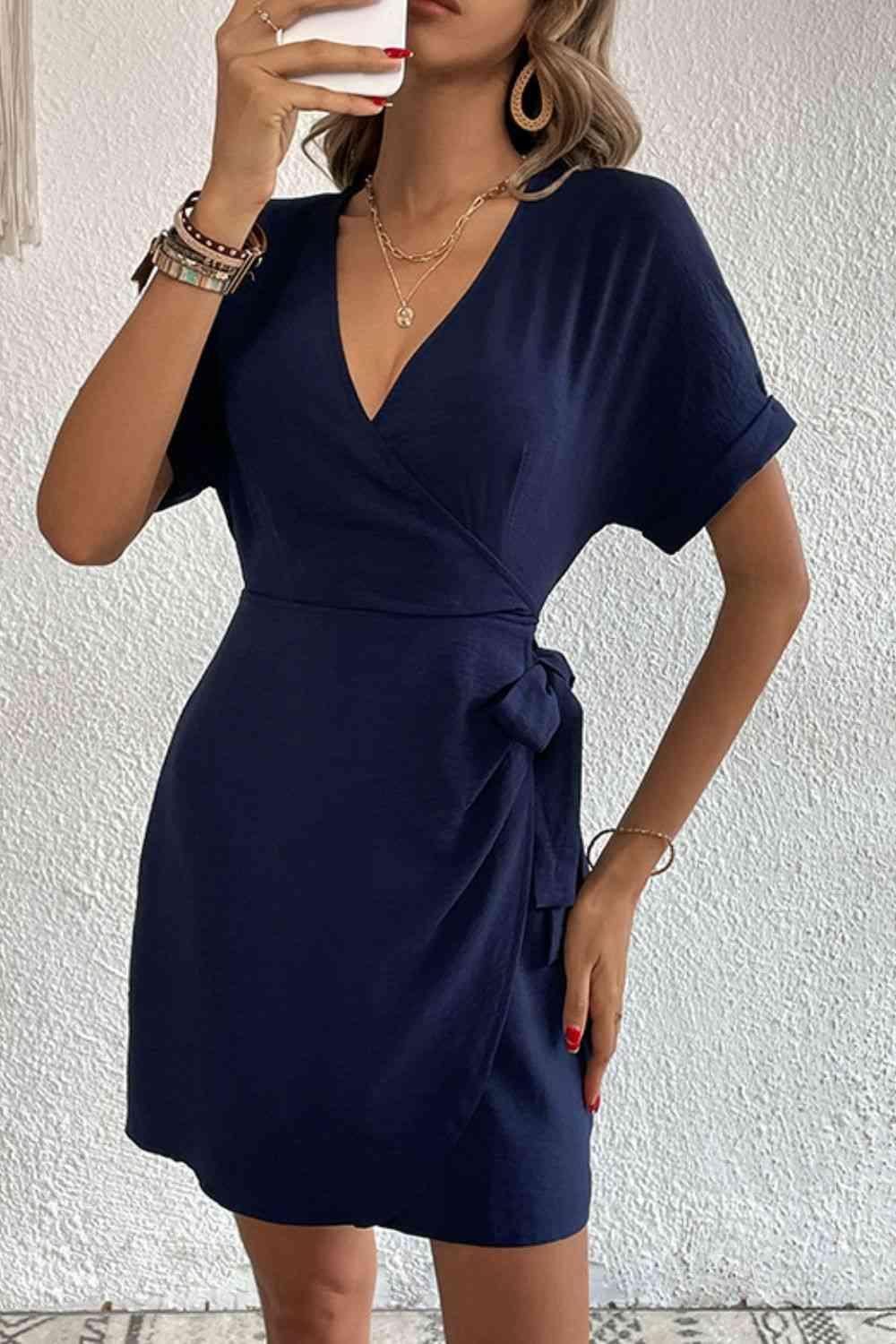 a woman taking a selfie in a blue dress