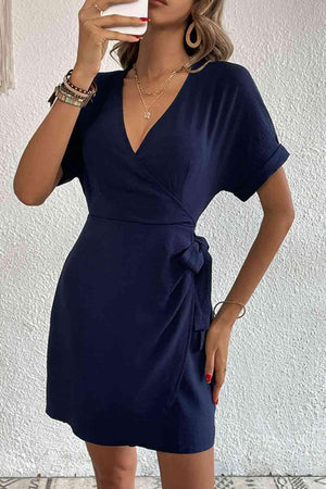 a woman taking a selfie in a blue dress