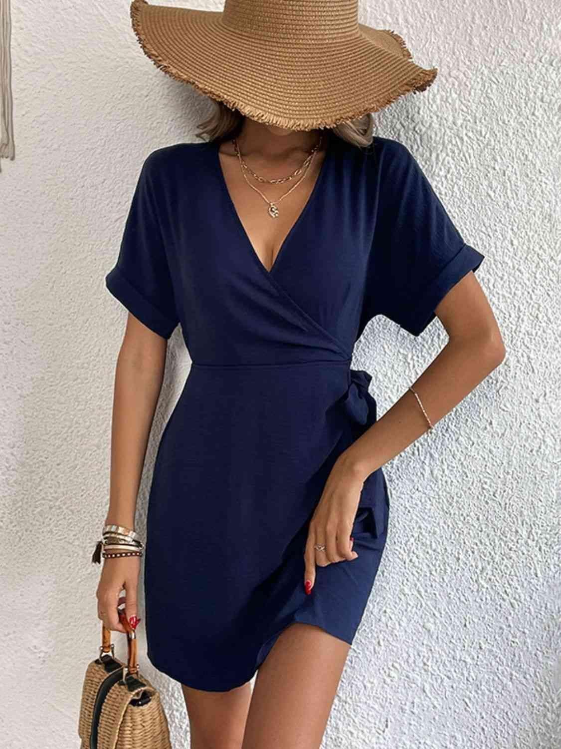 a woman wearing a blue dress and a straw hat