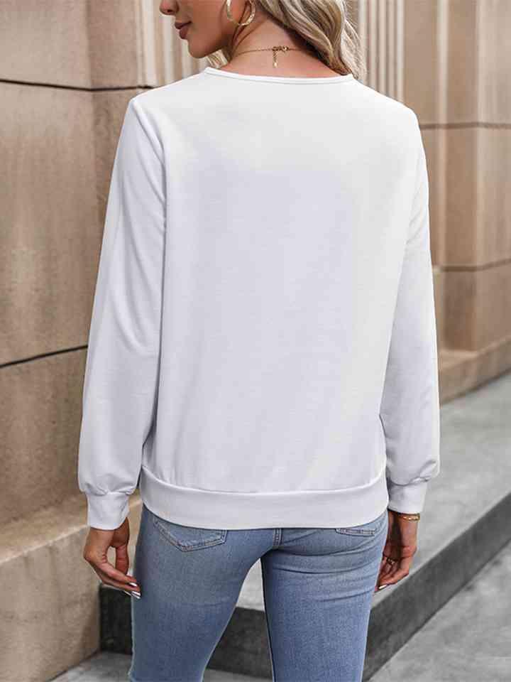 a woman wearing a white sweatshirt and jeans