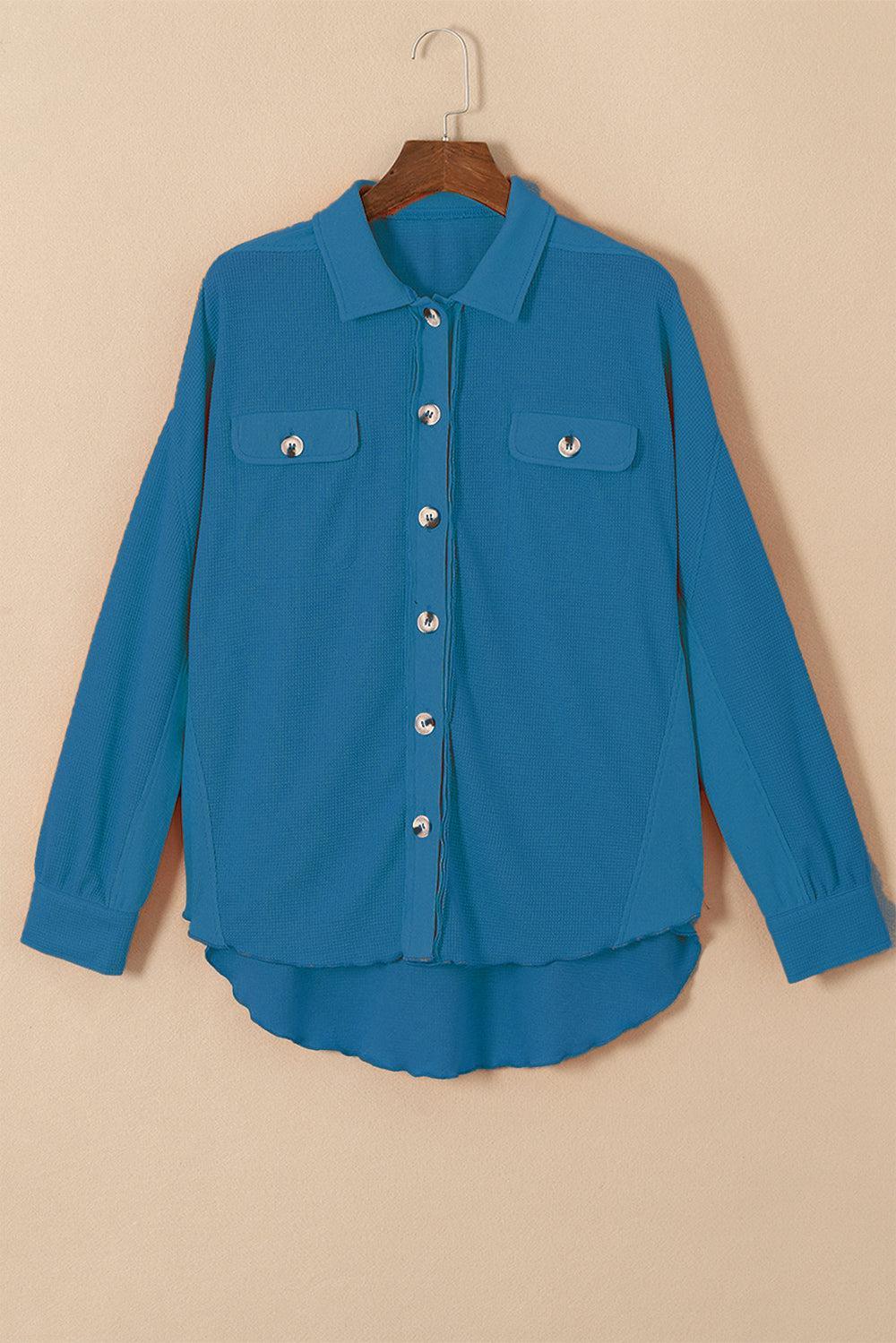 a blue jacket hanging on a hanger