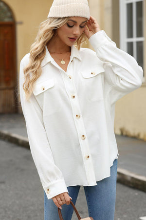 a woman wearing a white shirt and a hat