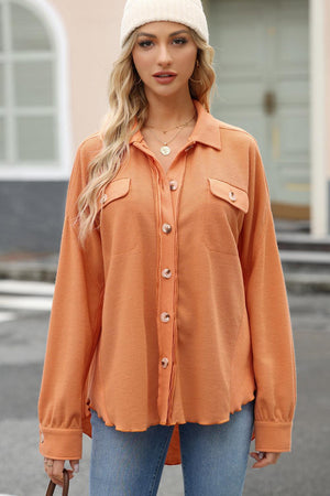 a woman wearing an orange shirt and a white hat