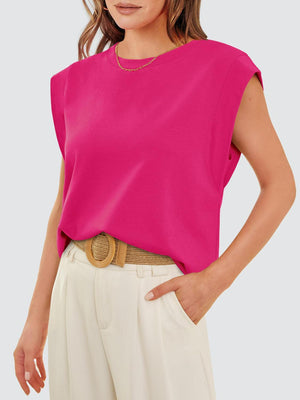 a woman wearing a pink top and white pants