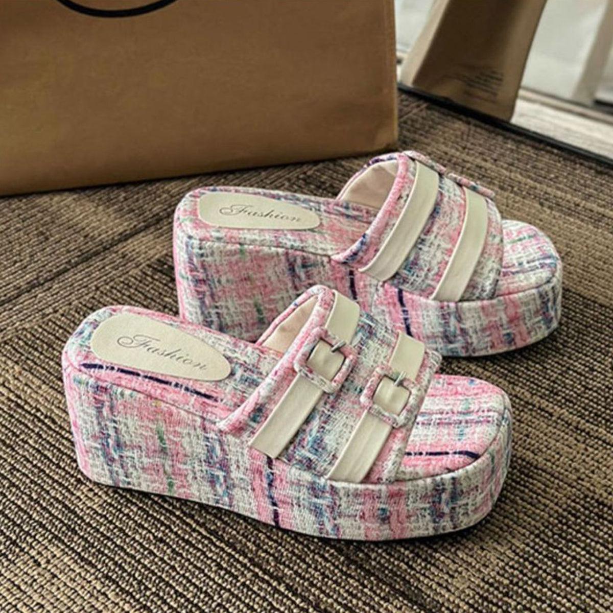 a pair of pink and white shoes sitting on top of a rug