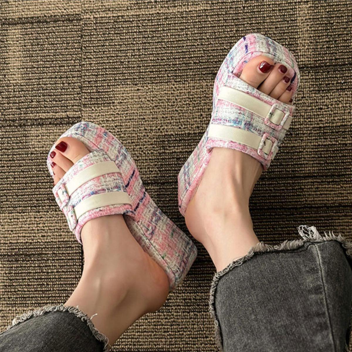 a woman's feet wearing a pair of sandals
