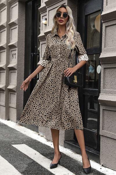 a woman in a leopard print dress and black heels