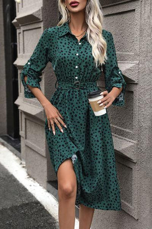 a woman wearing a green polka dot dress