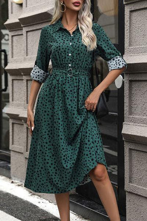 a woman wearing a green polka dot dress