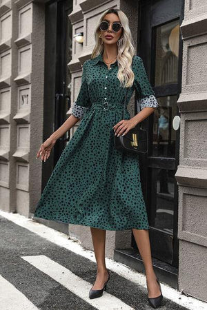 a woman wearing a green polka dot dress