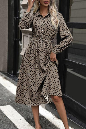 a woman in a leopard print dress