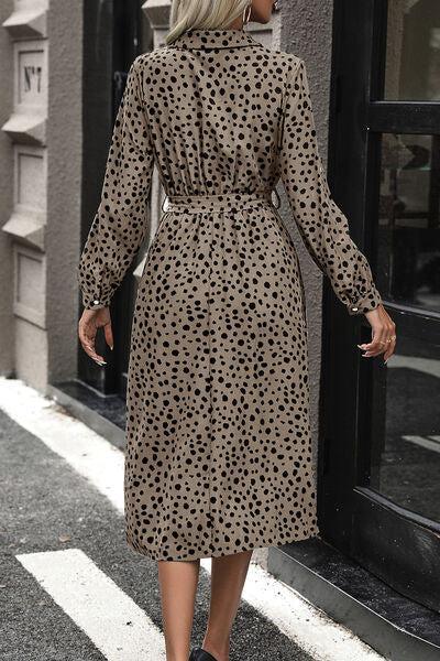 a woman walking down the street in a dress