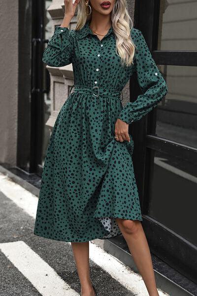 a woman wearing a green polka dot dress