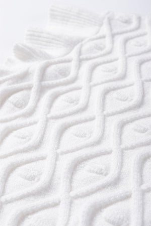 a close up of a towel on a white surface