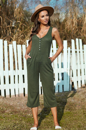 a woman wearing a green jumpsuit and a hat