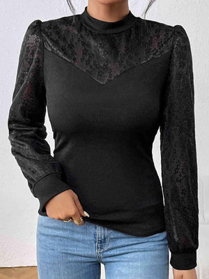 a woman wearing a black top and jeans