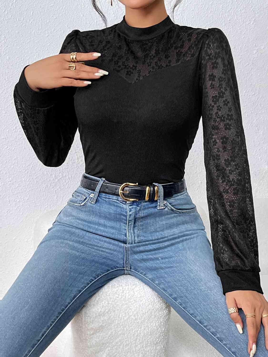 a woman wearing a black top and jeans