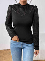 a woman wearing a black top and jeans