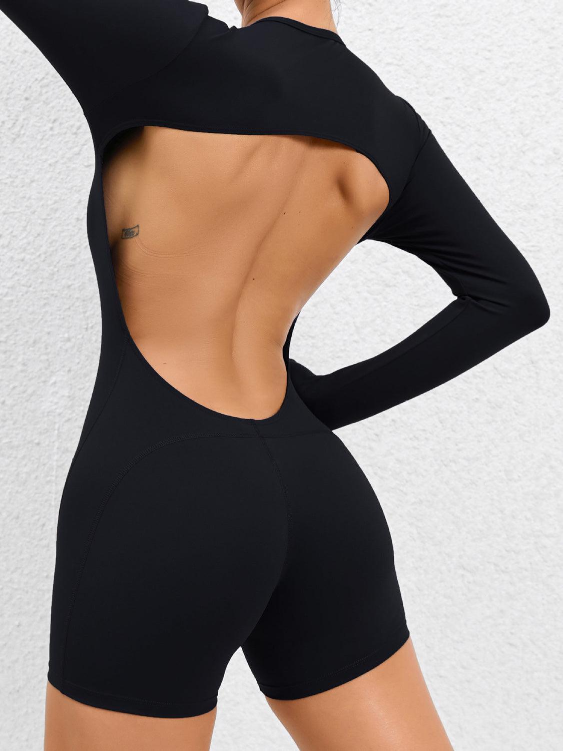 a woman in a black bodysuit with her back to the camera