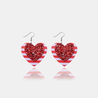 a pair of red and white heart shaped earrings