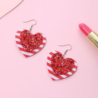 a pair of red and white heart shaped earrings