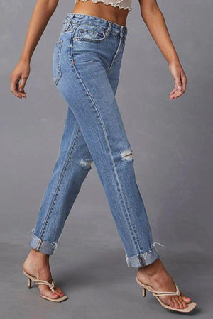 a woman in high waist jeans and a crop top