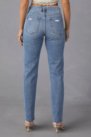 the back of a woman wearing high rise jeans