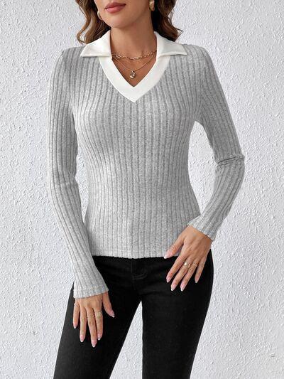 a woman wearing a white sweater and black pants