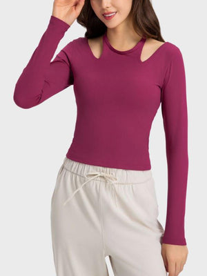 a woman wearing a purple top and white pants